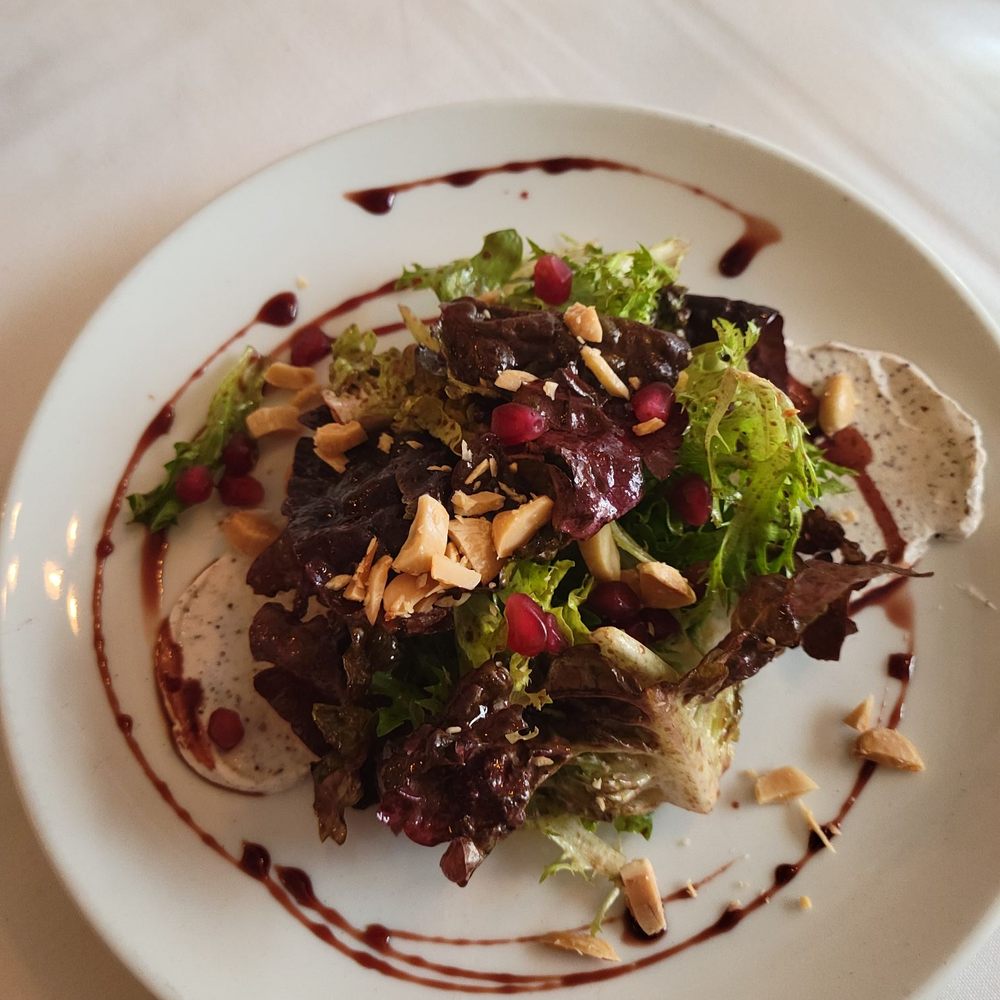 Bistro Barbes - a plate of salad on a table - French Near Me - Denver, Colorado