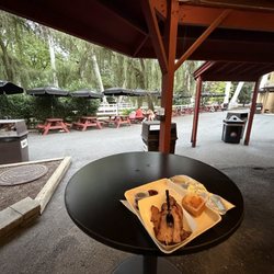 Spring Creek Smokehouse - Tables by the stream