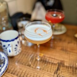 Singani Sour - singani 63, #8 organic pear liqueur, rosemary lavender bitters, honey, triplo, lemon, egg white