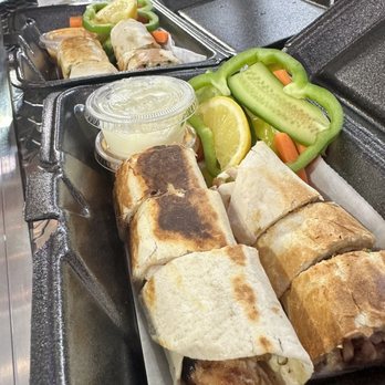 Shawarmaje - two trays of food on a conveyor belt - Food Trucks Near Me - Dearborn Heights, Michigan Shawarmaje - two trays of food on a conveyor belt - Food Trucks Near Me - Dearborn Heights, Michigan