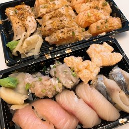 two trays of different types of sushi two trays of different types of sushi