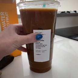 a hand holding a cup of coffee a hand holding a cup of coffee