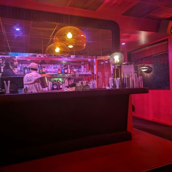 Waiting Room - a man in a hat at a bar - Cocktail Bars Near Me - Atlanta, Georgia