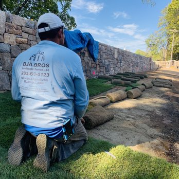 BJA Bros Landscaping Service - a man working on a retaining wall - Landscaping Near Me BJA Bros Landscaping Service - a man working on a retaining wall - Landscaping Near Me