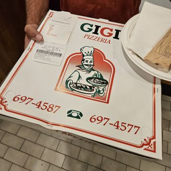 Gigi Pizzeria - a man holding a pizza box - Pizza Near Me - Pointe-Claire, Quebec Gigi Pizzeria - a man holding a pizza box - Pizza Near Me - Pointe-Claire, Quebec