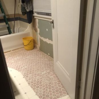 Ark Flooring and Trim - Before - 3/8" pink tile set in concrete, covered by white vinyl sheet. - Flooring Near Me - Kansas City, Missouri Ark Flooring and Trim - Before - 3/8" pink tile set in concrete, covered by white vinyl sheet. - Flooring Near Me - Kansas City, Missouri