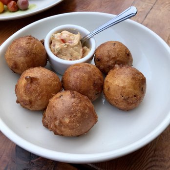 Curio - Corn Hush Puppies with sweet chili butter - Bars Near Me - San Francisco, California