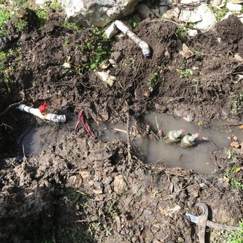 Flourish Irrigation - a man digging a hole in the ground - Landscaping Near Me - San Marcos, Texas Flourish Irrigation - a man digging a hole in the ground - Landscaping Near Me - San Marcos, Texas