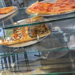 a variety of pizzas on display a variety of pizzas on display