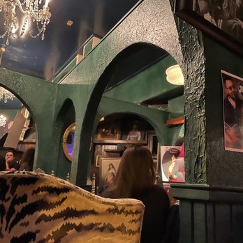 Lilly's - a woman sitting in a chair in a restaurant - Dive Bars Near Me - Chicago, Illinois