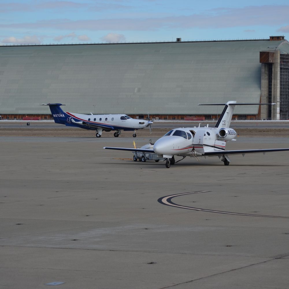 Moffett Federal Airfield - Pl-12 taxing behind a Cessna 510 - Airports Near Me - Mountain View, California Moffett Federal Airfield - Pl-12 taxing behind a Cessna 510 - Airports Near Me - Mountain View, California