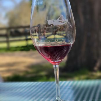 Thacher Winery - a glass of wine on a table - Wineries Near Me - Paso Robles, California Thacher Winery - a glass of wine on a table - Wineries Near Me - Paso Robles, California