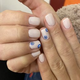 Gel manicure with evil eye design Gel manicure with evil eye design