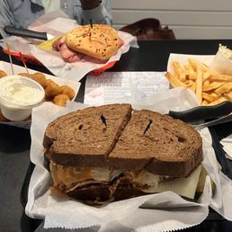Turkey Reuben, corn beef sandwich on onion roll, fried mushrooms, French fries