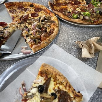 Roma's Pizza And Grill - a table full of pizzas - Italian Near Me - Dallas, Texas