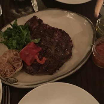 Balvanera - "ANCHO" 16oz Ribeye. Medium rare w roasted garlic, red pepper, and greens. Served w side salad, chimis, and fries. - Argentine Near Me - New York, New York Balvanera - "ANCHO" 16oz Ribeye. Medium rare w roasted garlic, red pepper, and greens. Served w side salad, chimis, and fries. - Argentine Near Me - New York, New York