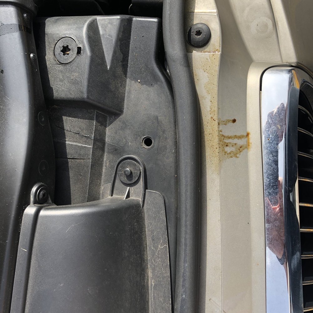 Oil stains down the front of the car. Oil stains down the front of the car.