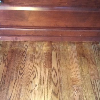Advanced Hardwood Flooring - Next to oven in kitchen. Uneven spots by fireplace also in living room/kitchen by island bar. - Flooring Near Me - Niles, Michigan