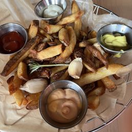 Pommes Frites (French fries) with ketchup and aiolis: garlic, spicy chili and curry.