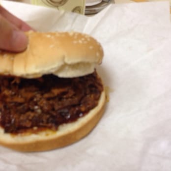Dash Inn - a hand reaching for a pulled pork sandwich - Burgers Near Me - Buffalo, Wyoming Dash Inn - a hand reaching for a pulled pork sandwich - Burgers Near Me - Buffalo, Wyoming