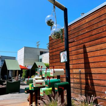 Milk & Honey - a street corner with mail boxes and a street light - Coffee & Tea Near Me - Costa Mesa, California