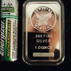 Citadel Coins - They call these "1 oz bars", but it's more of a wafer. I put a AA battery next to it so you get a sense of the size. Reflective too! :D