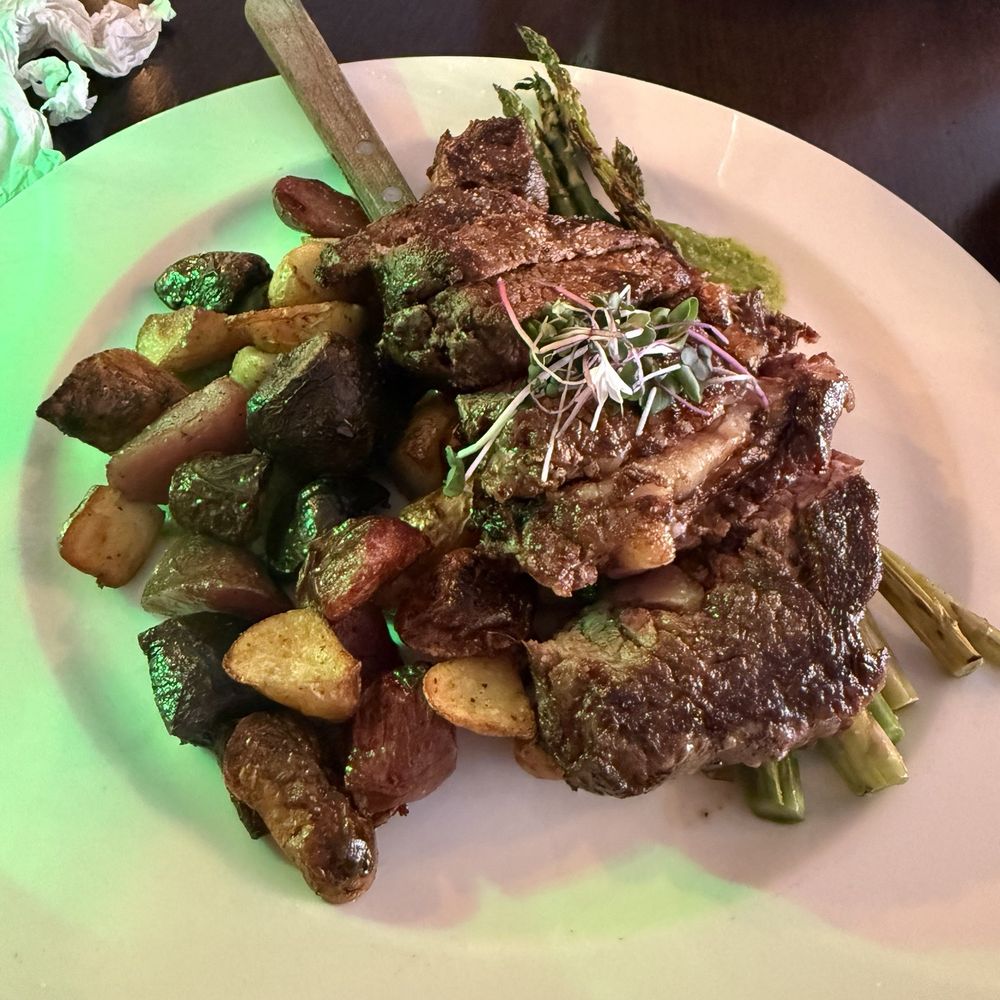 The Frybread Lounge - Bison Ribeye -  $55 HICKORY SMOKED RIBEYE | ROASTED POTATO MEDLEY | BABY CARROTS | INDIGENOUS PESTO - Lounges Near Me - Scottsdale, Arizona