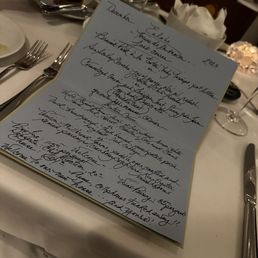 a handwritten menu on a table a handwritten menu on a table