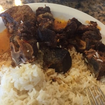 Mo's Restaurant - This is the dry and hard and extremely salty goat dish that I couldn't eat, the rice is undercooked and gritty too - Haitian Near Me - Key West, Florida