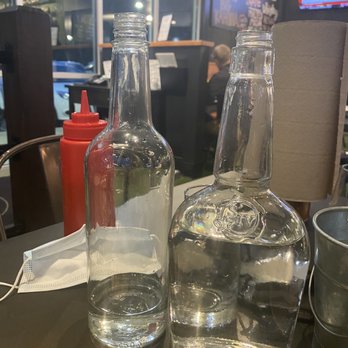 Stack 571 Burger & Whiskey Bar - Water is served at the tables in empty whiskey bottles - American Near Me - Lake Tapps, Washington Stack 571 Burger & Whiskey Bar - Water is served at the tables in empty whiskey bottles - American Near Me - Lake Tapps, Washington