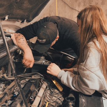 Elevated Auto Repair - James MacMillan showing daughter what he's working on - Auto Repair Near Me - Sheridan, Wyoming Elevated Auto Repair - James MacMillan showing daughter what he's working on - Auto Repair Near Me - Sheridan, Wyoming