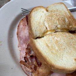 Texas sandwich with tasty bacon plenty  of it ! and ham with just the right amount of egg fried hard