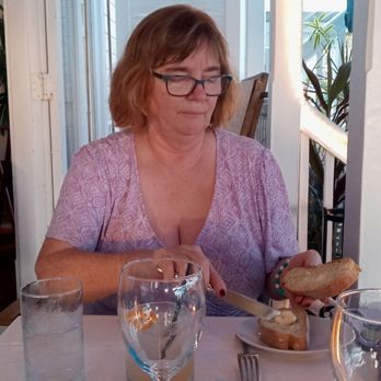 Louie's Backyard - Meg enjoying deliciously warm Louie's bread. - New American Near Me - Key West, Florida Louie's Backyard - Meg enjoying deliciously warm Louie's bread. - New American Near Me - Key West, Florida