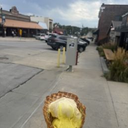 Lemon verbena (top) and Golden Milk (bottom) two-scoop waffle cone, with a view toward Coneflower Creamery (on the left side of the street) Lemon verbena (top) and Golden Milk (bottom) two-scoop waffle cone, with a view toward Coneflower Creamery (on the left side of the street)