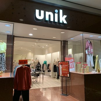 Unik - Storefront-11/17/22 - Clothing boutique Unik in Brea, CA, features a storefront with mannequins displaying fashion items and signs advertising a holiday sale. - Women's Clothing Near Me - Brea, California
