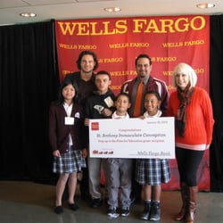 St Anthony's Immaculate Conception - Principal Miguel Martinez with several students and Brandon Crawford from the S.F. Giants receiving a scholarship for our school