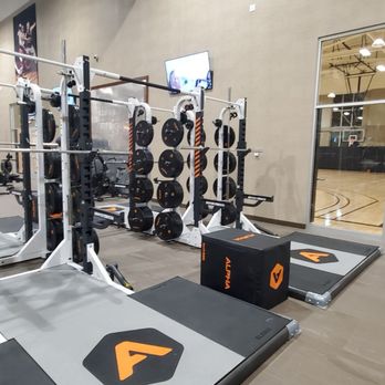 Life Time - Smith machines & basketball court in the background - Gyms Near Me - Houston, Texas Life Time - Smith machines & basketball court in the background - Gyms Near Me - Houston, Texas