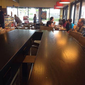 Einstein Bros. Bagels - Sitting at end of high table with booths and other tables visible. - Bagels Near Me - Long Beach, California Einstein Bros. Bagels - Sitting at end of high table with booths and other tables visible. - Bagels Near Me - Long Beach, California
