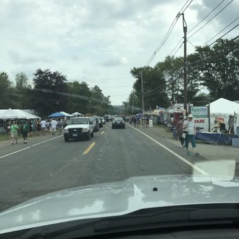 Brimfield Flea Markets - Lots of slow moving traffic and people walking on both sides of the road - Flea Markets Near Me - Brimfield, Massachusetts