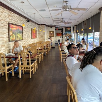 Chalan on the Beach - people sitting at tables in a restaurant - Latin American Near Me - Miami Beach, Florida Chalan on the Beach - people sitting at tables in a restaurant - Latin American Near Me - Miami Beach, Florida