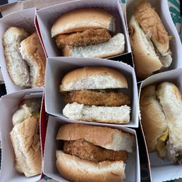 six hot dogs in boxes on a table