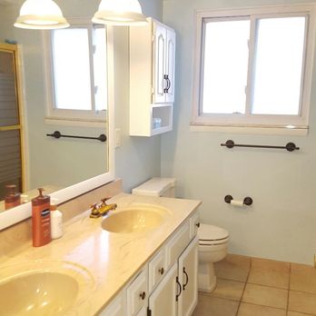 Fresh Image - After photo of a bathroom we painted. Drywall repair, cabinets painted white and walls painted in clean and bright color - General Contractors Near Me - Canton, Michigan