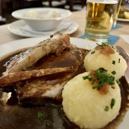 Yeast and potato dumplings served with pork roast