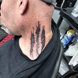 Neck tattoo black and grey mixed with color