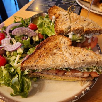 Caffe Social - Salmon burger on multi-grain bread with a salad on the side. - American Near Me - Norwalk, Connecticut