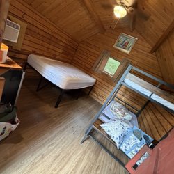 Brunswick Beaches Campground - Inside has a full bed and bunk beds and a mini fridge