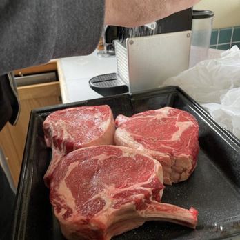 Bullseye Marketplace - a man preparing steaks on a pan - Grocery Near Me - Three Rivers, Michigan