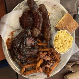 Platter with sausage, chicken, sweet potato fries, Mac and cheese, and cornbread. Platter with sausage, chicken, sweet potato fries, Mac and cheese, and cornbread.