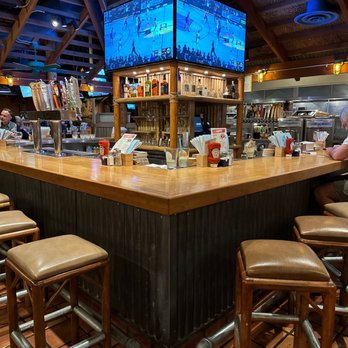 Islands Restaurant - a bar with stools and televisions - Burgers Near Me - Temecula, California