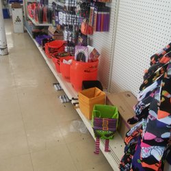 Dollar Tree - Unkempt store with boxes on shelves